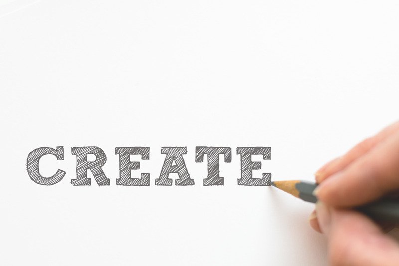 The word "Create" sketched out on a piece of paper