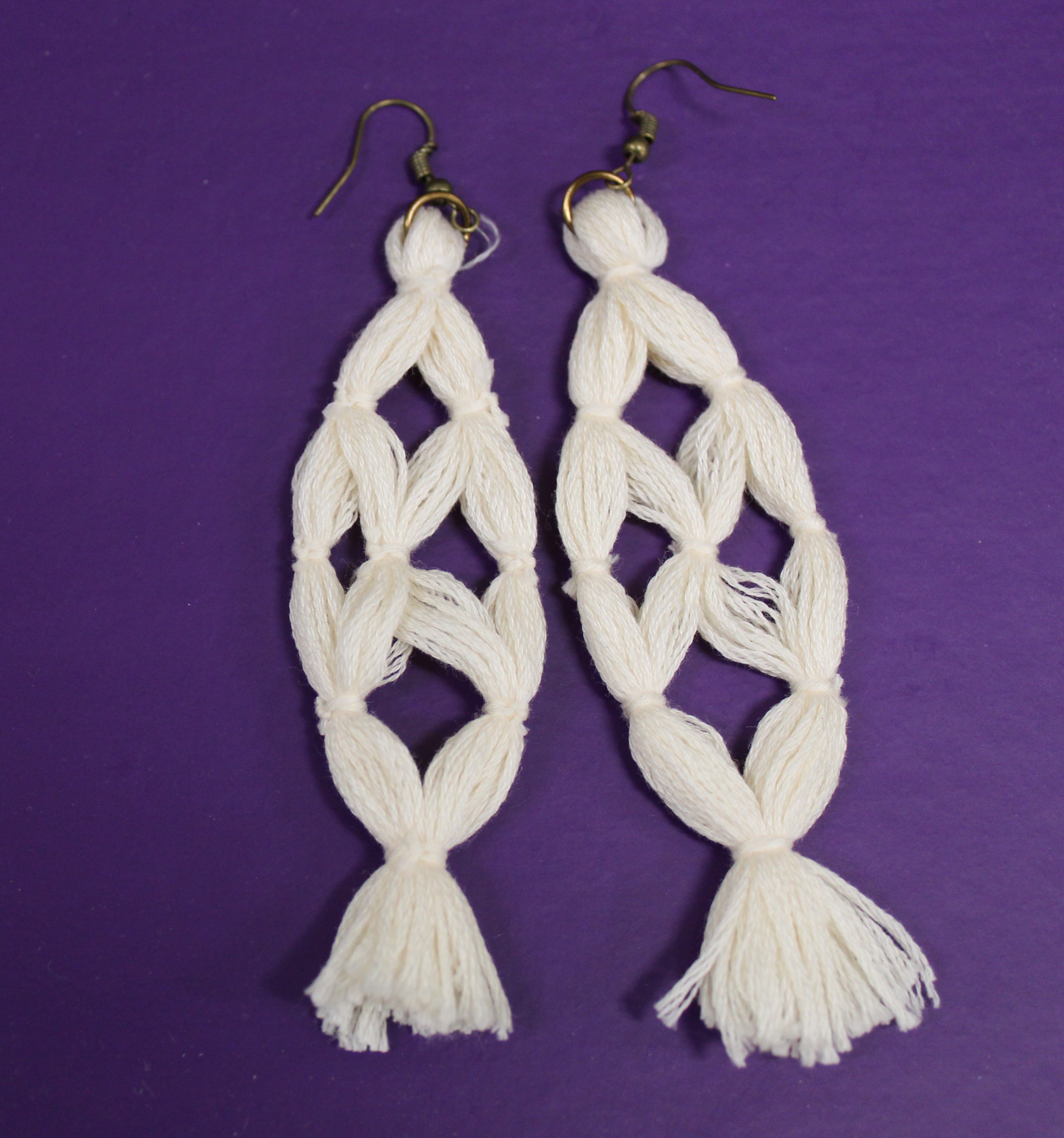 Image of a pair of white tassel earrings