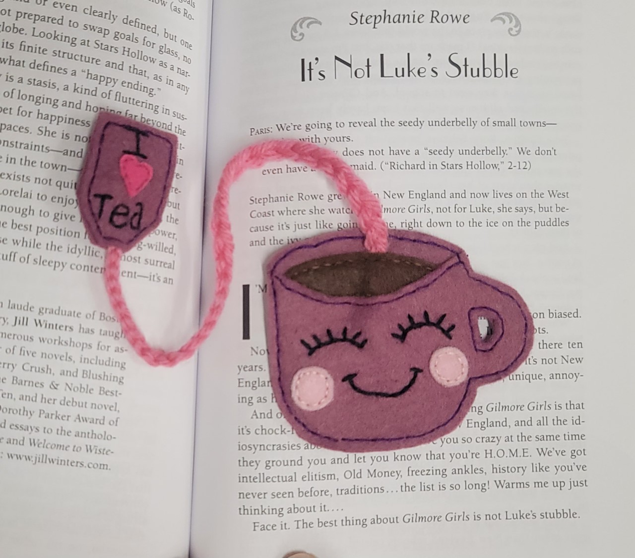 A pink felt tea cup with a smiley face. 