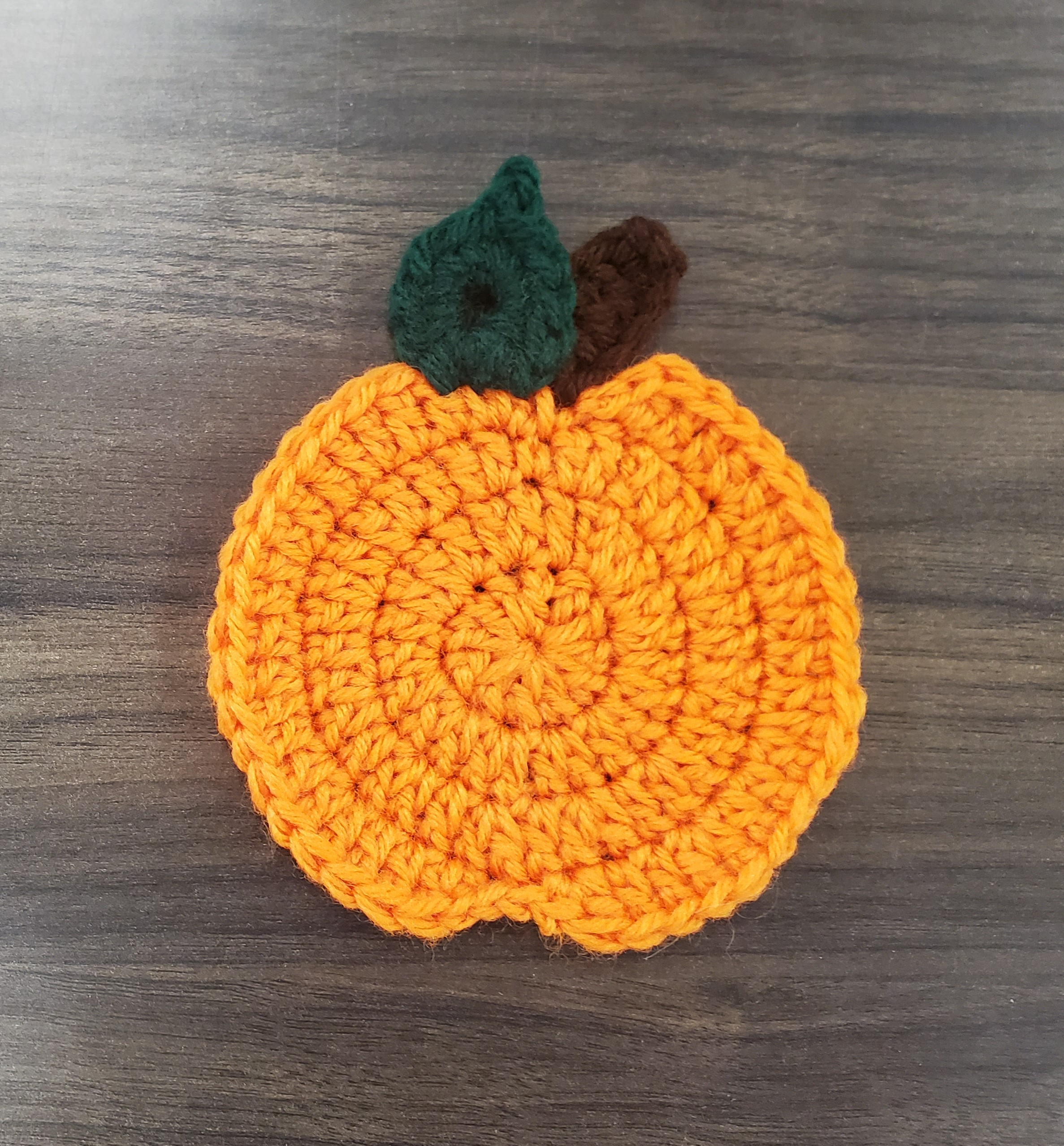crochet coaster made to look like a pumpkin