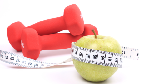Weights, measuring tape, and a green apple