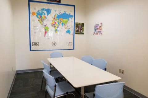 Youth Media Room with table, chairs, and wall map