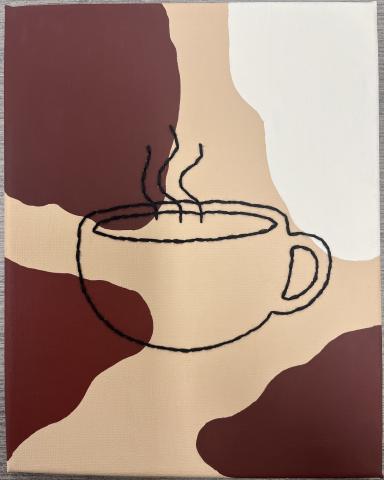 Picture of an embroidered coffee cup in black thread on a canvas with a tan background and brown colored splotches