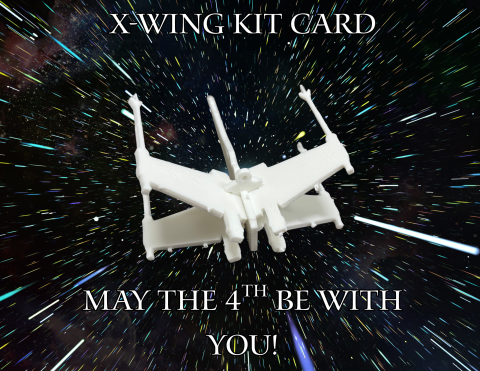 A picture reading X-WING KIT CARD MAY THE 4TH BE WITH YOU with an X-Wing model.